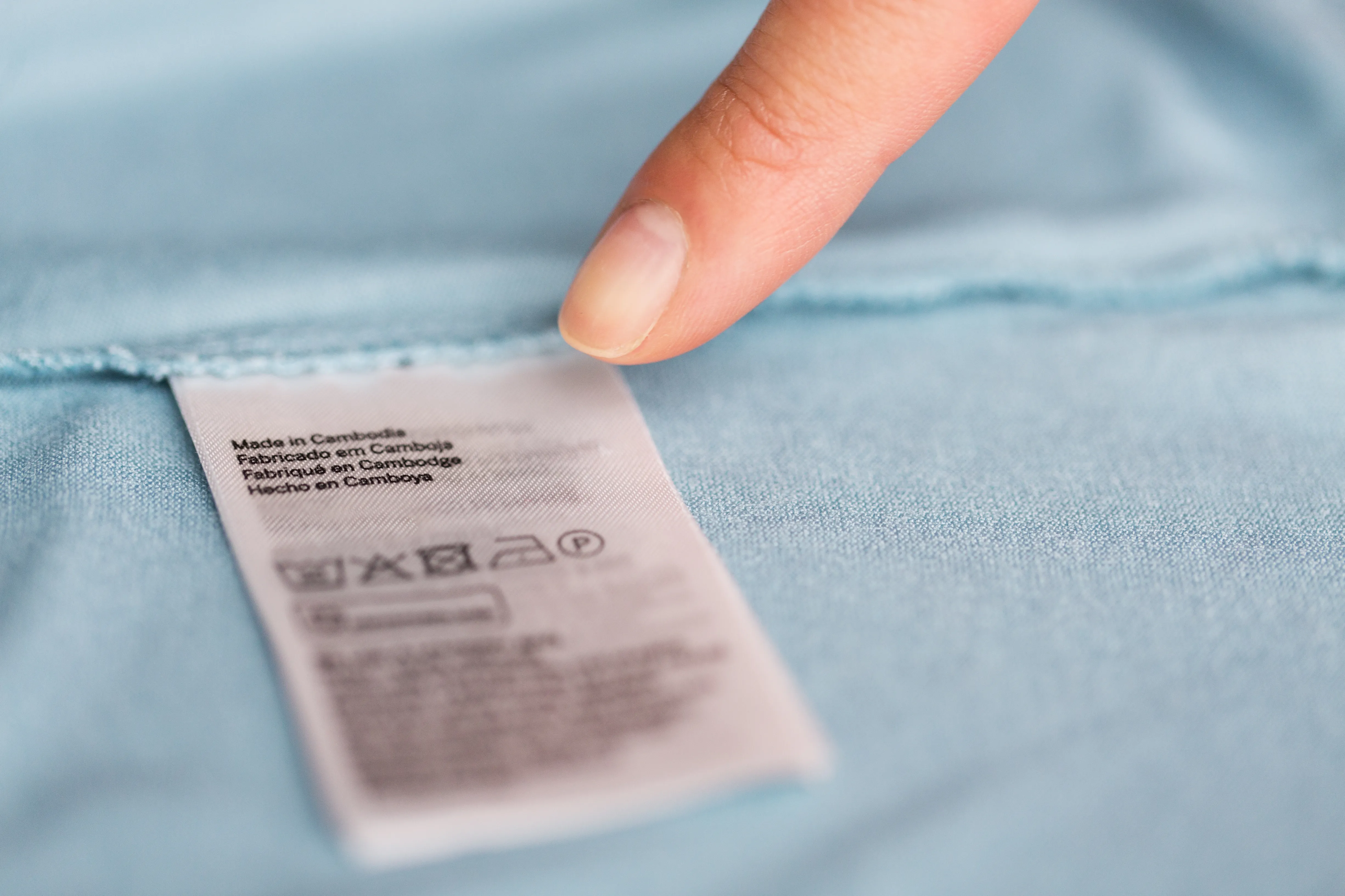 finger-pointing-to-users-manual-of-clothing-2024-09-27-19-00-55-utc